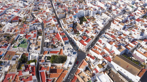 Aerial drone perspective of white town in Andalusia, Conil de la Frontera seen from above. Typical south Spanish town top view