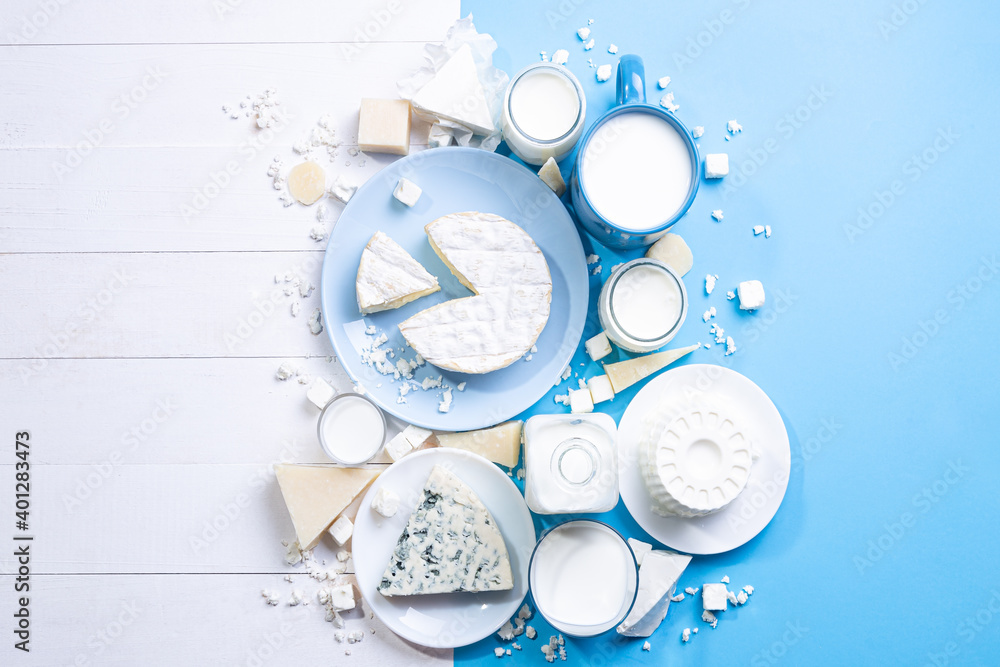 Dairy products on white wood  and blue background  with  copy space. Top view , flat lay. - obrazy, fototapety, plakaty 