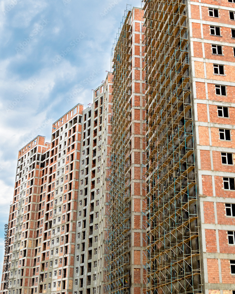 Fototapeta premium High buildings with scaffold at the construction site