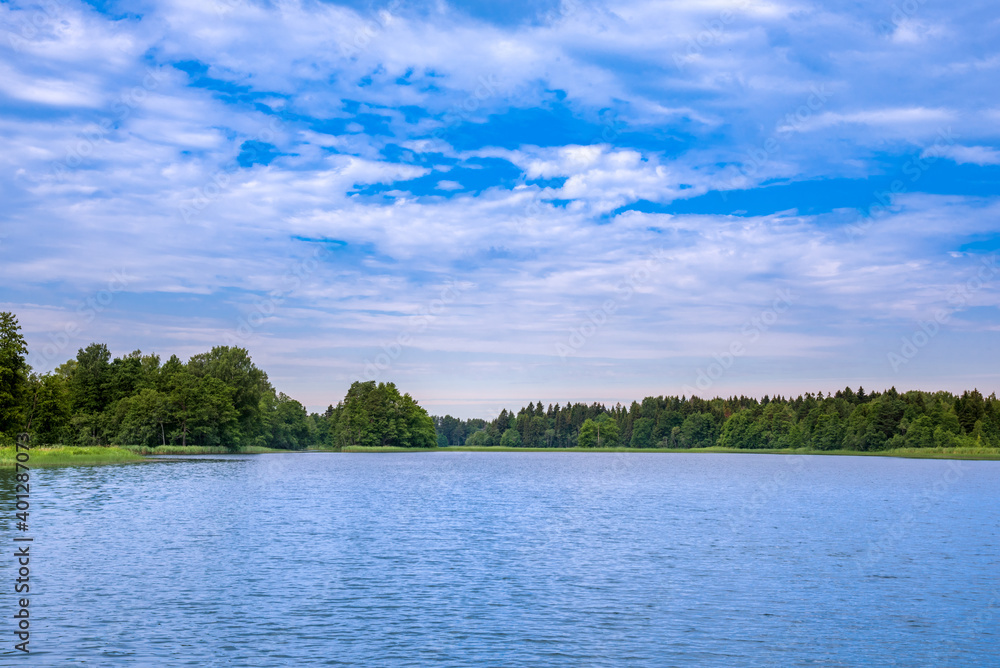 Summer landscape with lake, forest and blue sky clouds Summer landscape with lake, forest and blue sky clouds