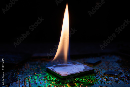 The flame is on the central processor that lies on the printed circuit board. Low-key photo. photo