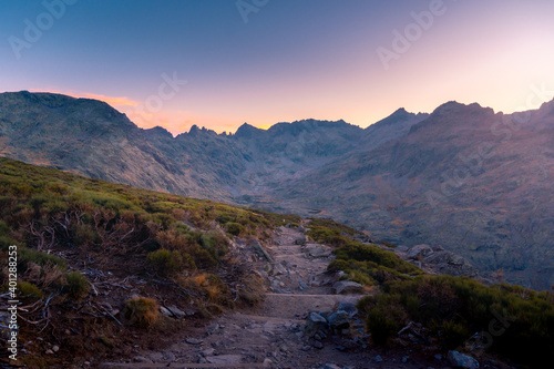 Scenery view of shabby path between moss in mounts under colorful sky at sundown in Sierra de Gredos photo