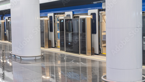 Metro or underground Station and Train. Modern metro station with high speed subway train at platform. No people. Space for text.