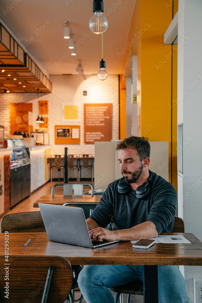 man sitting in a coffee shop while working with laptop man sitting in a coffee shop while working with laptop