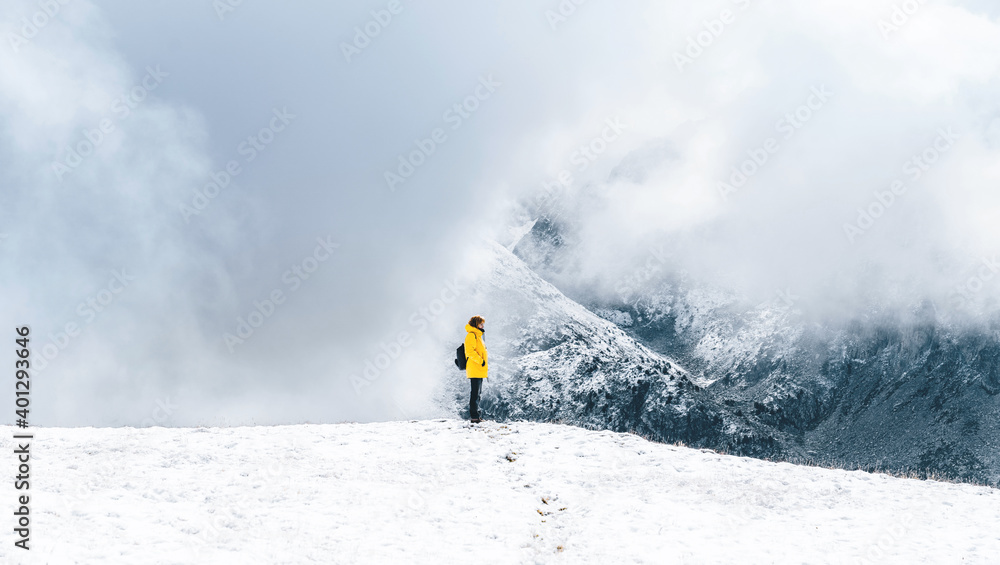 Side view of anonymous hiker with trekking poles walking on snowy ground in Pyrenees mountains in Andorra Side view of anonymous hiker with trekking poles walking on snowy ground in Pyrenees mountains in Andorra