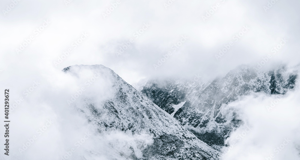 Majestic panoramic scenery of rough rocky slopes of Pyrenees mountain range covered with snow under cloudy sky in El Pas de la Casa Majestic panoramic scenery of rough rocky slopes of Pyrenees mountain range covered with snow under cloudy sky in El Pas de la Casa