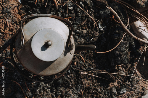 Kettle over charcoal during camping trip