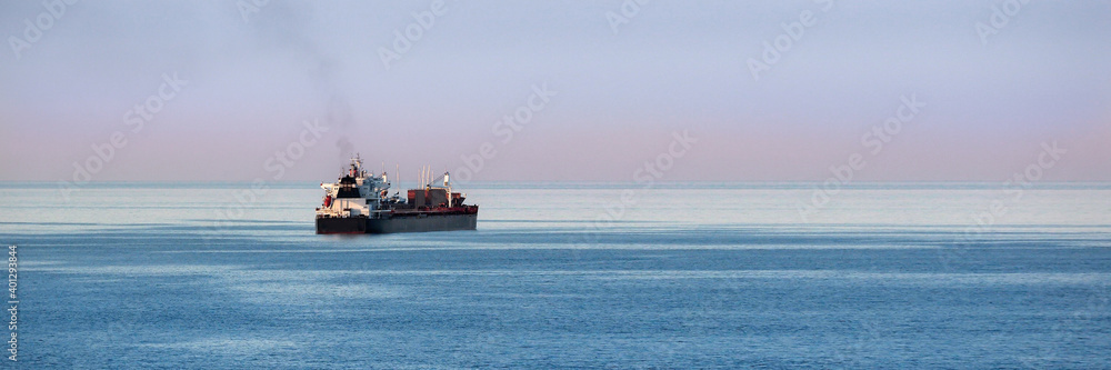 Panorama view of cargo ship on the open sea   