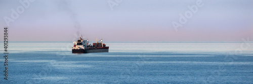 Panorama view of cargo ship on the open sea   