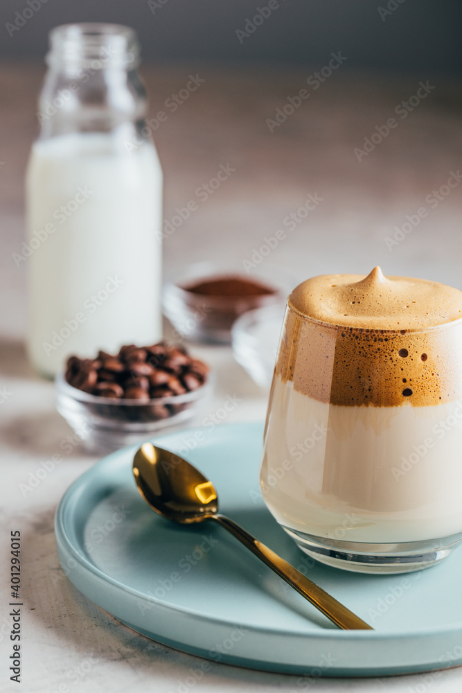 From above of tasty cold Dalgona coffee in glass served on table with bottle of milk From above of tasty cold Dalgona coffee in glass served on table with bottle of milk