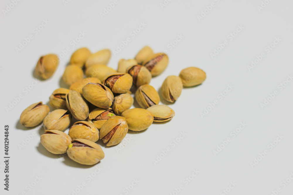 a handful of pistachios that lie on a white background