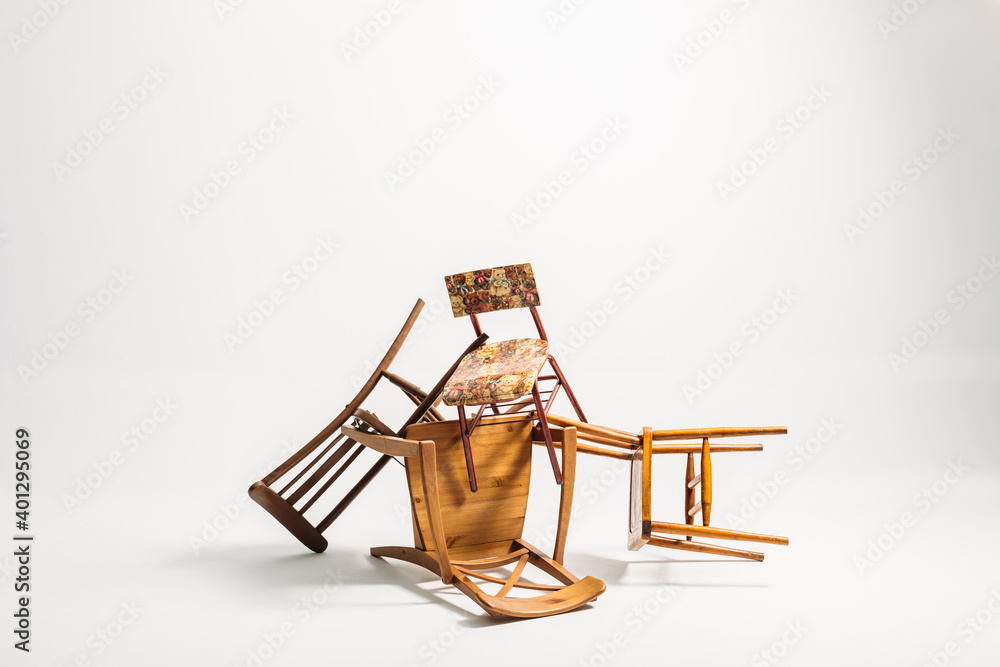Set of old chairs stacked against white background