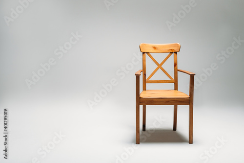 Classical wooden chair isolated against gray background photo