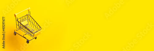 flying empty trolley on a bright yellow background. Close-up. Banner.