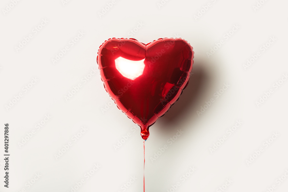 red air balloon in the form of a heart on a white background