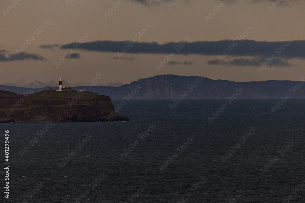 Rathlin Island East lighthouse from Murlough Bay with the Isle of Islay in Scotland on the horizon, Ballycastle, Causeway coast and Glens, County Antrim, Northern Ireland