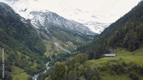 Scenery view of green landscape and snowy mountain peak in Switzerland.