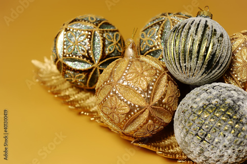 Christmas balls. Christmastime, happy new year concept. Mustard christmas decoration on beige background.
