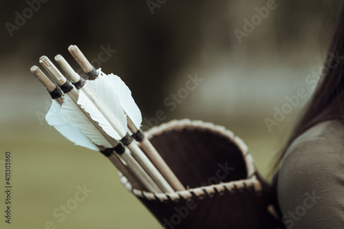 Ancient quiver with arrows on the back of a woman archer