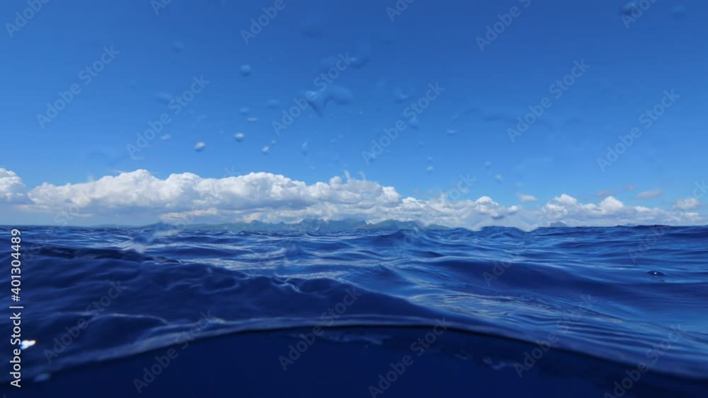 Plastic bag floating in blue water of sea, camera approaching to it Plastic bag floating in blue water of sea, camera approaching to it