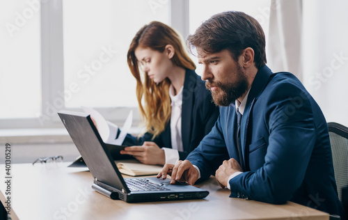 Business colleague at work at work desk laptop financial professionals