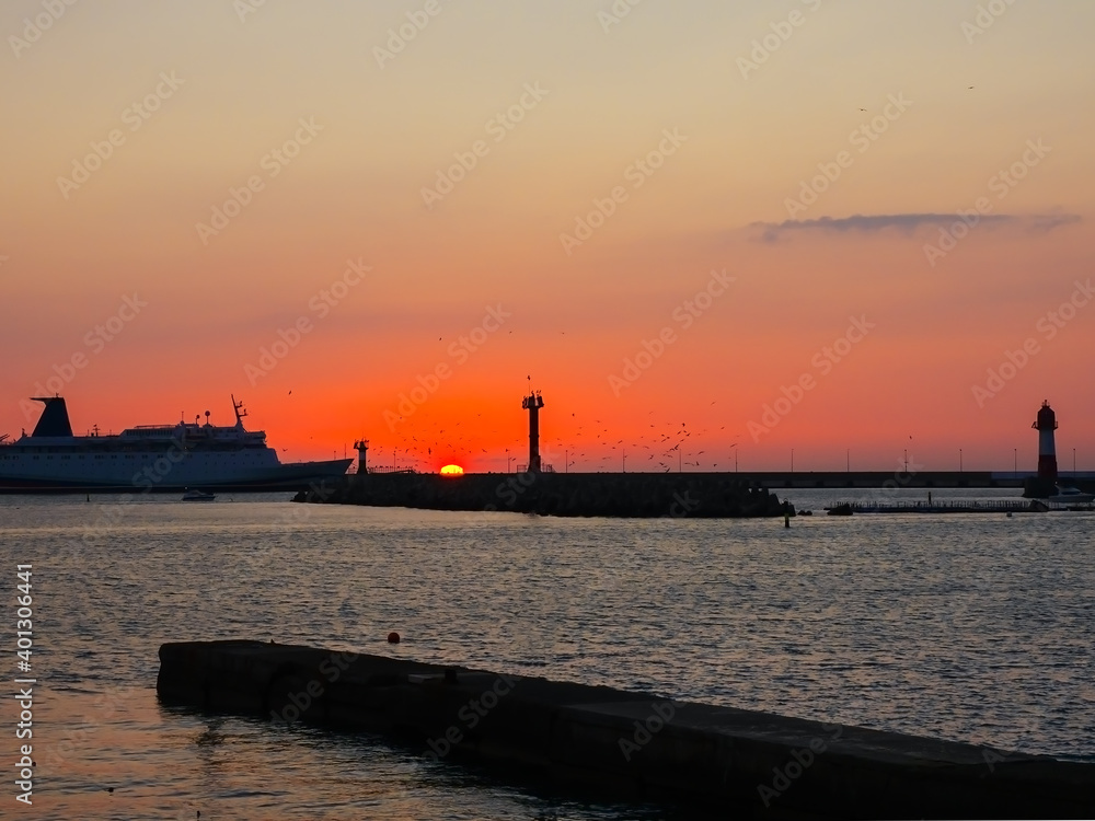 The ship enters the bay against the backdrop of the setting sun The ship enters the bay against the backdrop of the setting sun