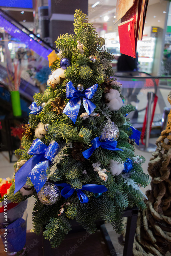 decorative Christmas tree decorated with toys in the shopping center.