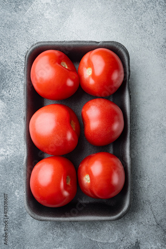 Red ripe tomatoe, on gray background