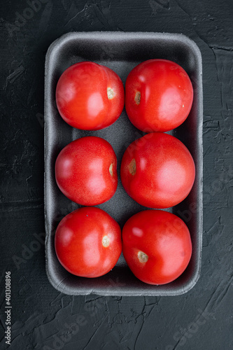 Fresh red organic tomatoe, on black background