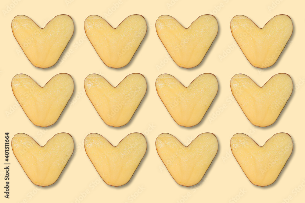 natural heart-shaped potatoes on light background