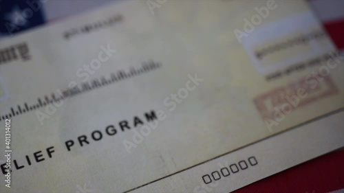Blurring Stimulus check  relief program on Flag of USA, close up view. 