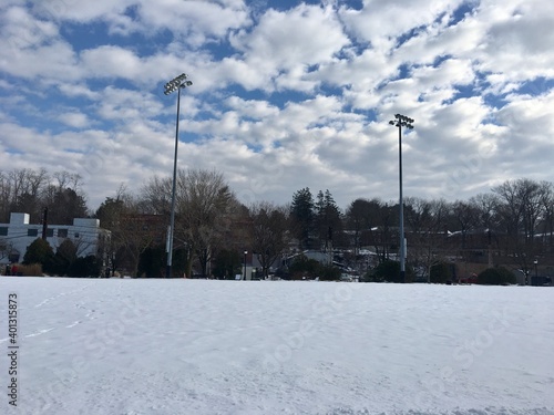 Winter scene, park, river, snow, blue sky, bare trees