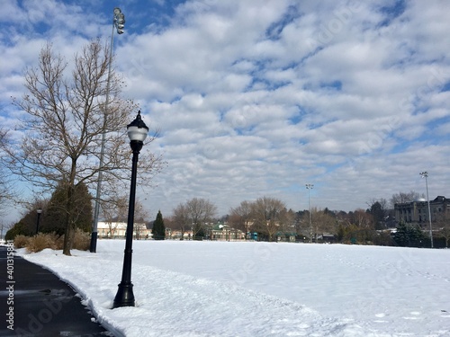 Winter scene, park, river, snow, blue sky, bare trees