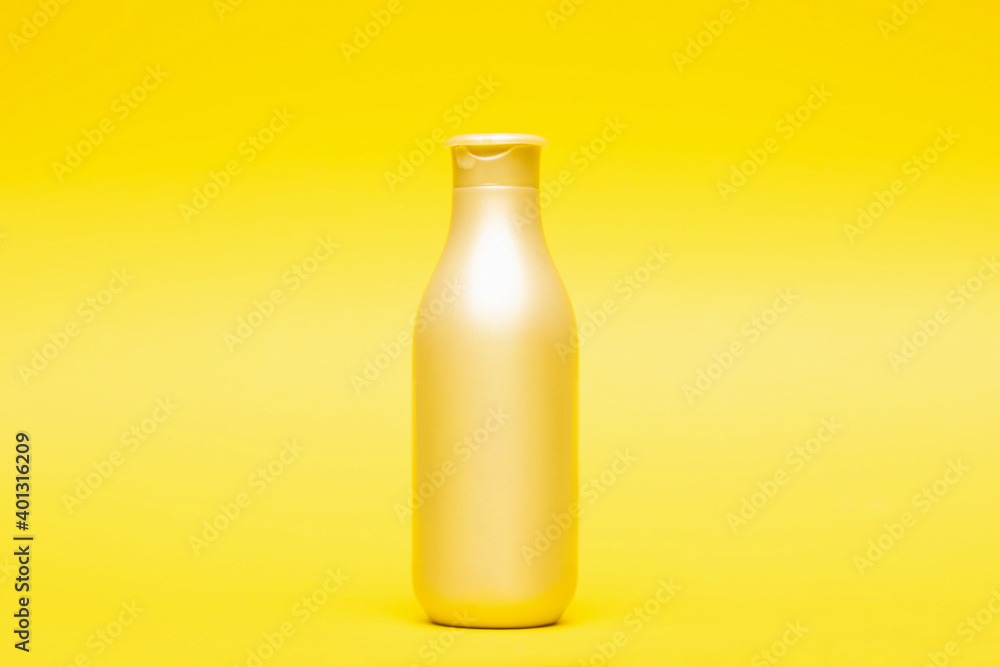 Bottle for shampoo and conditioner on yellow background, hair care and treatment product Bottle for shampoo and conditioner on yellow background, hair care and treatment product