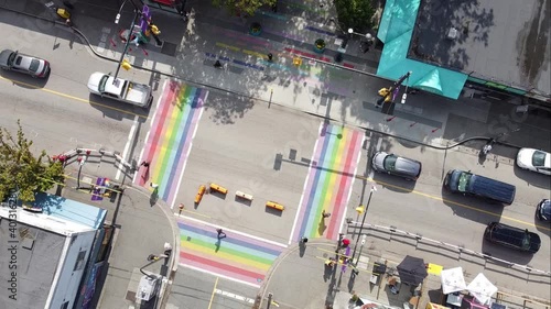 super slow aerial twist over gay pride LGBTQ downtown community with 4 painted road flags describing sexuality of the village davie and bute vancouver canada 2-2 photo
