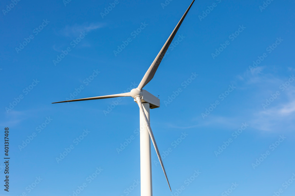 A large three blade industrial wind turbine generating electricity A large three blade industrial wind turbine generating electricity