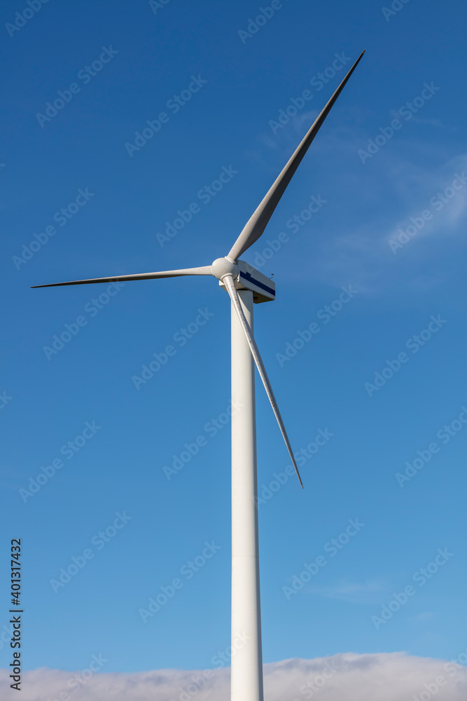 A large three blade industrial wind turbine generating electricity A large three blade industrial wind turbine generating electricity
