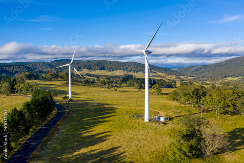 Aerial view of a large three blade industrial wind turbine generating electricity