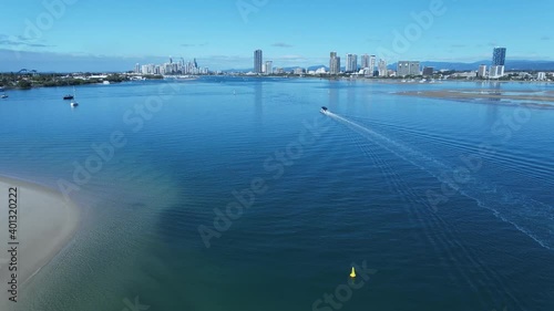 Wallpaper Mural A slow moving boat glides through the clear calm water as it heads towards a city skyline Torontodigital.ca