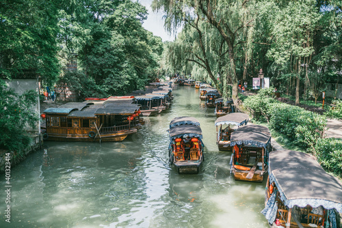 Traditional ancient town architecture in Jiangnan, China. Travel destination of Nanxun Ancient Town, river with 
Chinese traditional wooden boat. photo