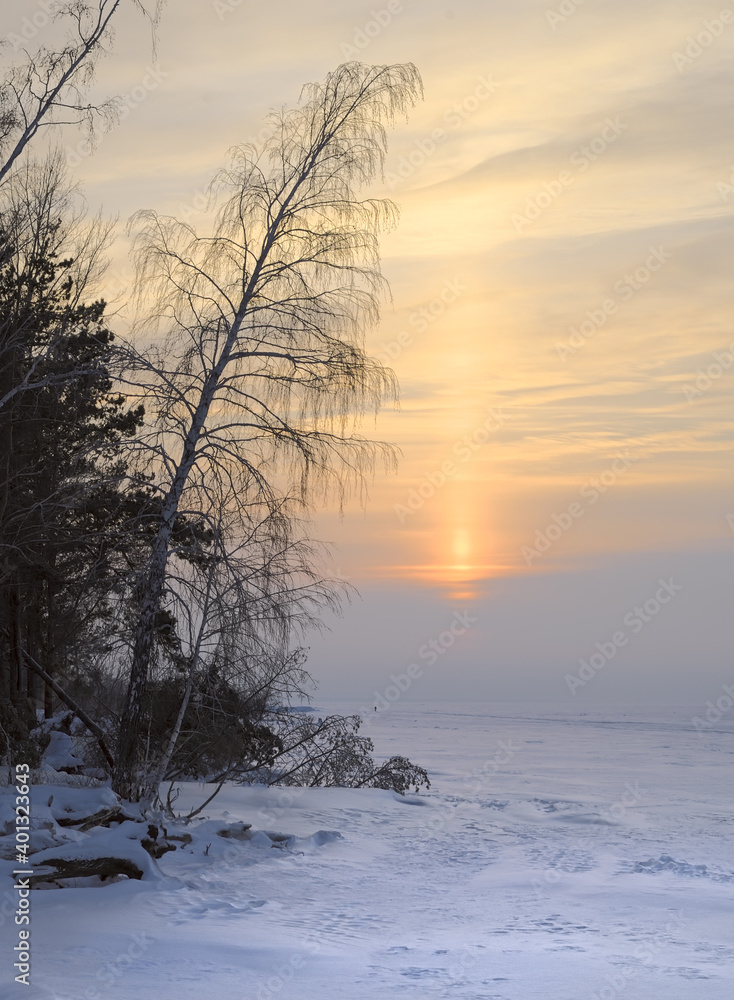 Sunset over the winter snow-covered plain Sunset over the winter snow-covered plain