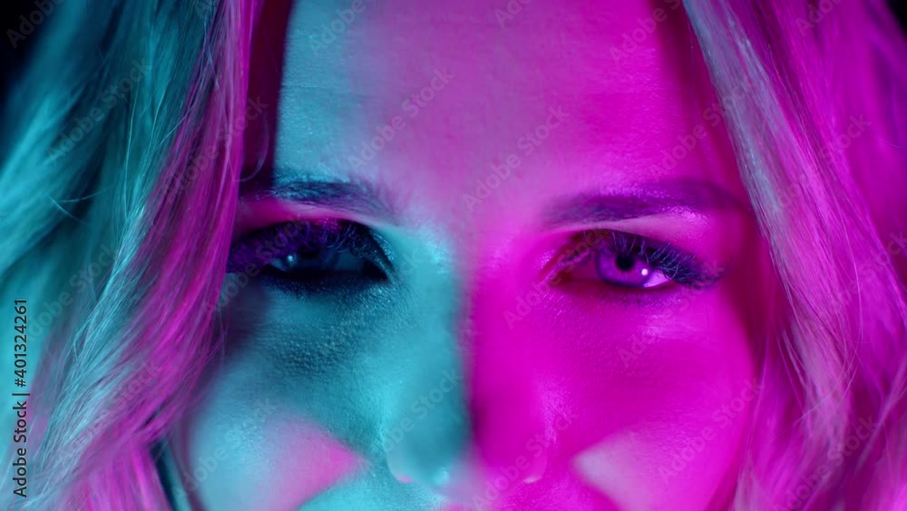 Sensual emotional blonde girl with bright makeup slowly opening eyes in pink green neon lights. Nightlife, nightclub, discotheque concept extreme close-up, 4k footage. Slow motion Sensual emotional blonde girl with bright makeup slowly opening eyes in pink green neon lights. Nightlife, nightclub, discotheque concept extreme close-up, 4k footage. Slow motion