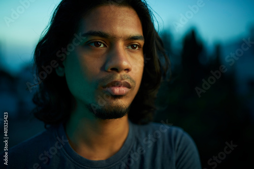 Photography Young man portrait with long hair in evening light