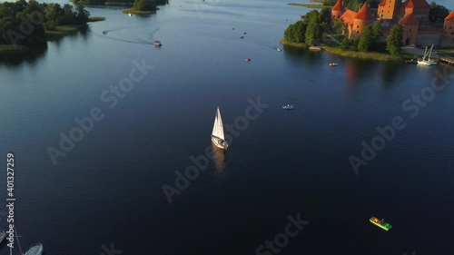 orbiting my 4k drone around a yacht by the red medieval castle photo