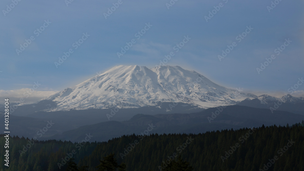 A distant view from the valley toward a snow covered Mt. St. Helens, Skamania County