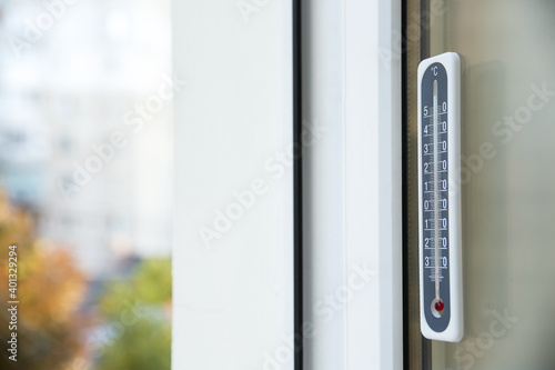 Weather thermometer on outside window. Space for text