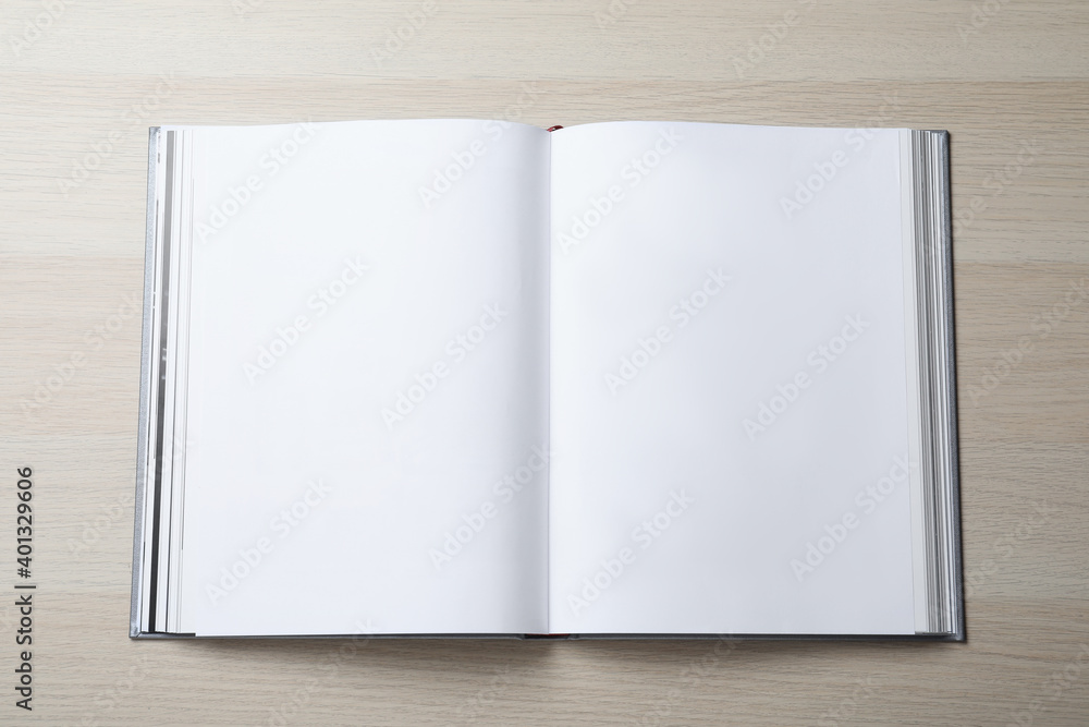 Open book with hard cover on wooden table, top view Open book with hard cover on wooden table, top view