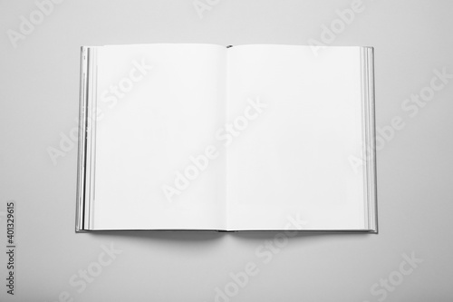 Open book with hard cover on white background, top view