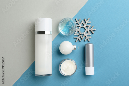 Flat lay composition with different cosmetic products on color background. Winter care