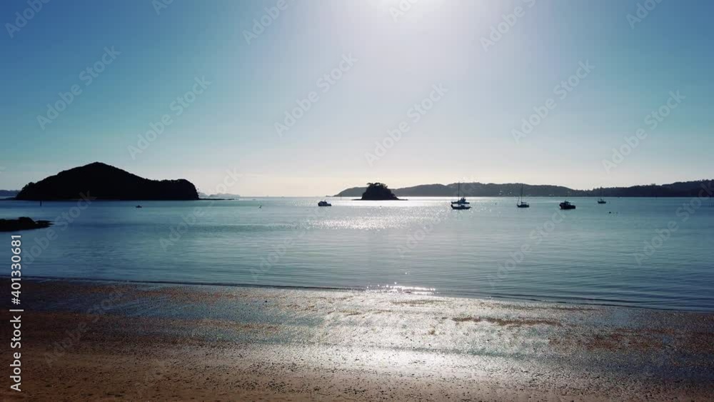 Scenic View Of Nature - Floating Boats At The Calm Beach At Bay Of Islands Under Sunlight In New Zealand. - Static Shot Scenic View Of Nature - Floating Boats At The Calm Beach At Bay Of Islands Under Sunlight In New Zealand. - Static Shot